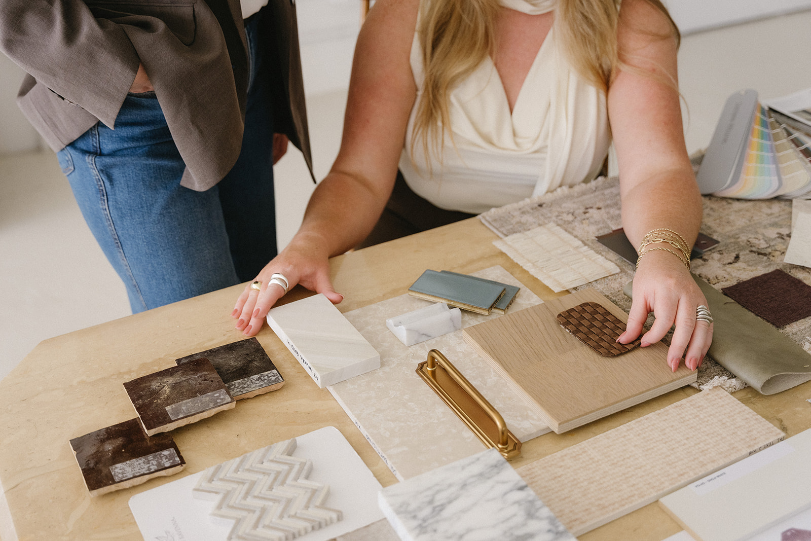 Courtney Meredith and Kelsey Noel reviewing fabric samples in their Denver studio